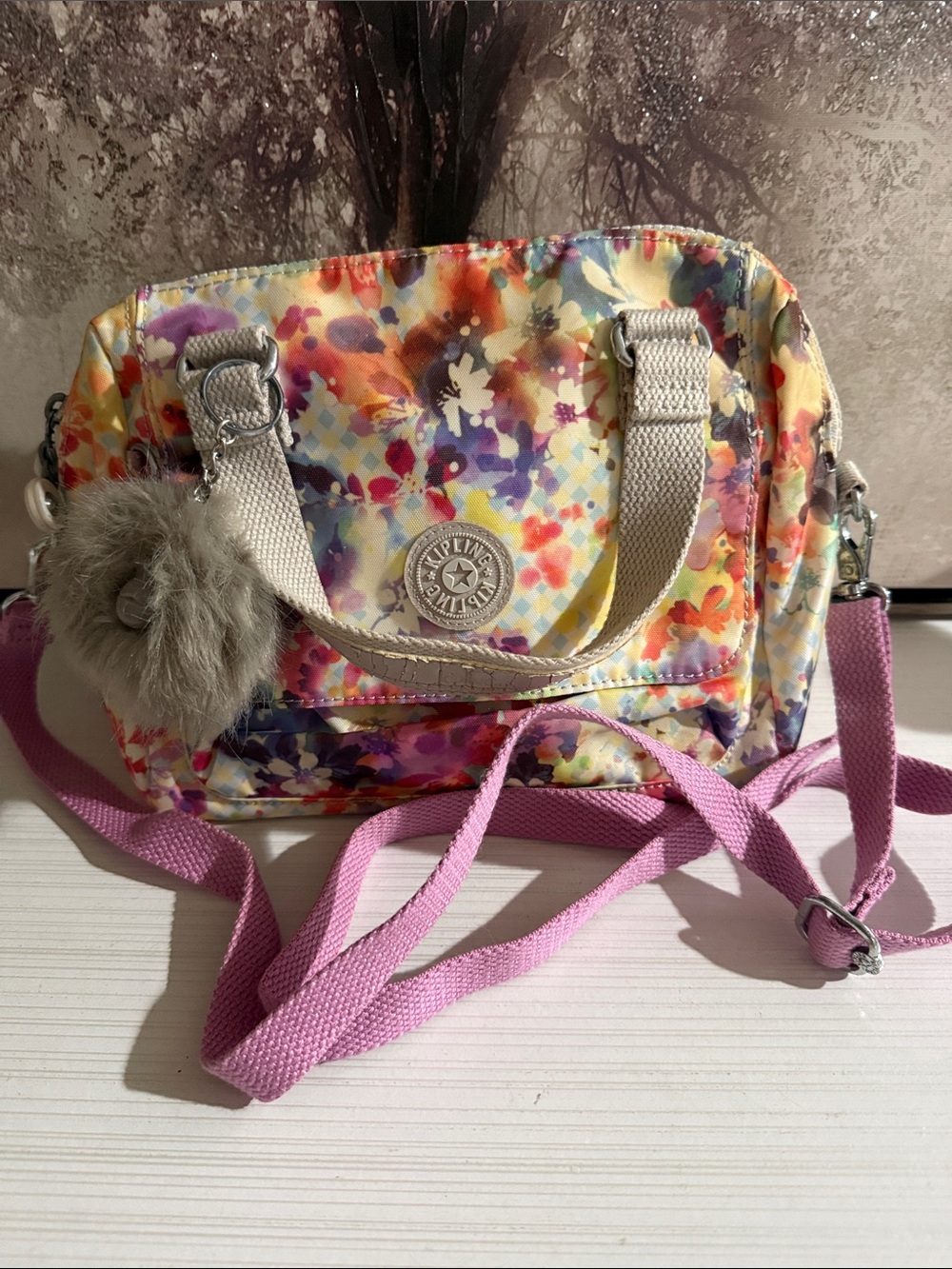 Kipling multicolor floral print crossbody handles have cracks